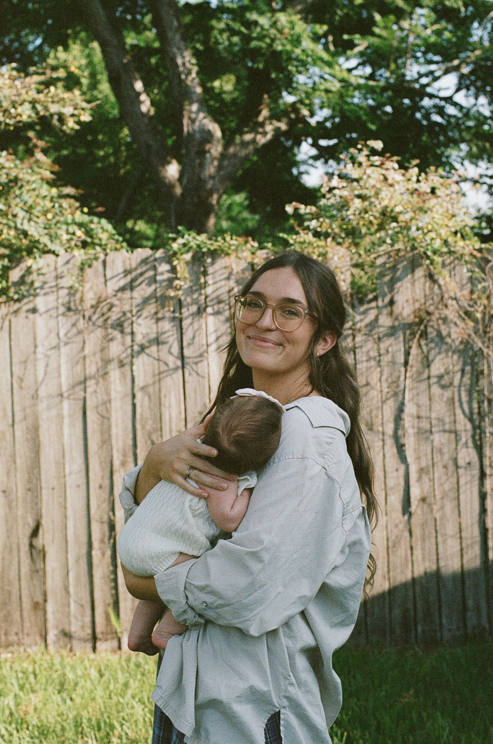 Mom holding her baby and smiling at camera by Shelby Ann Photos