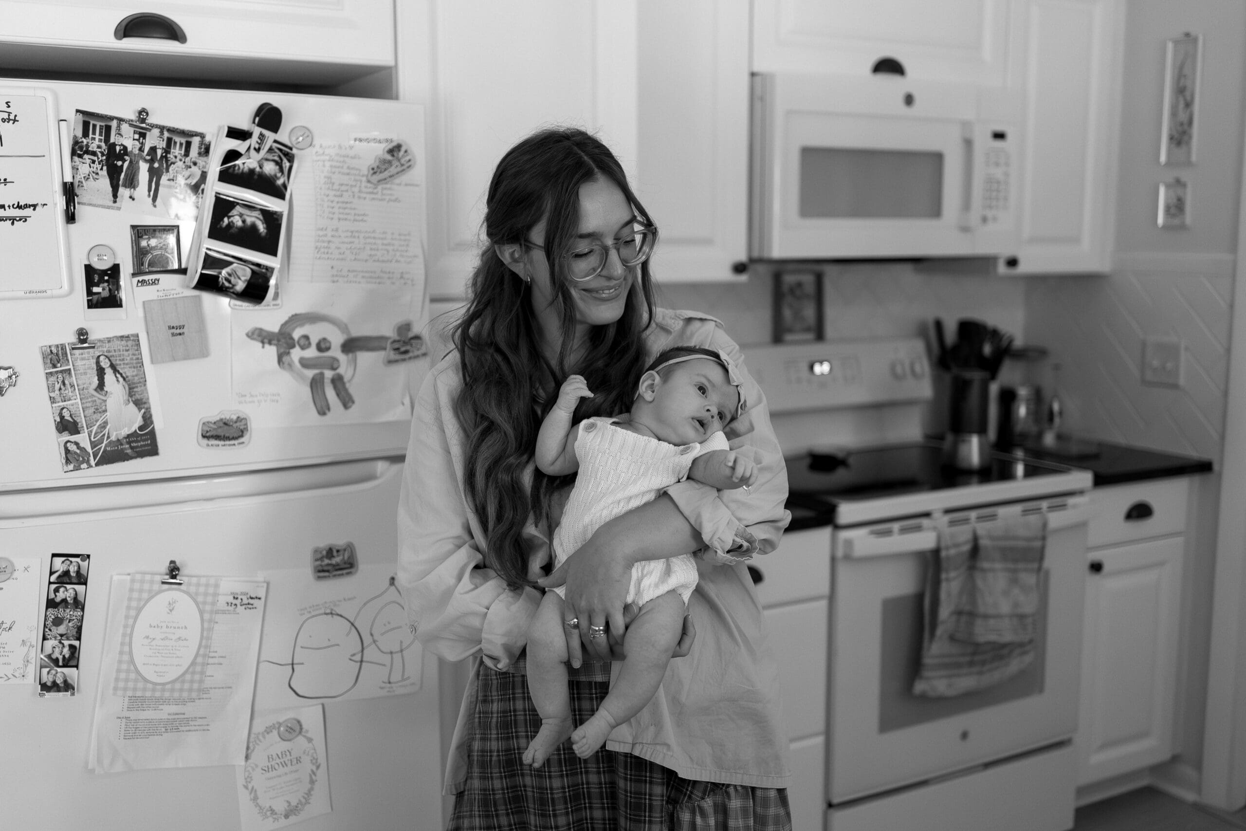 Mom holding baby in kitchen