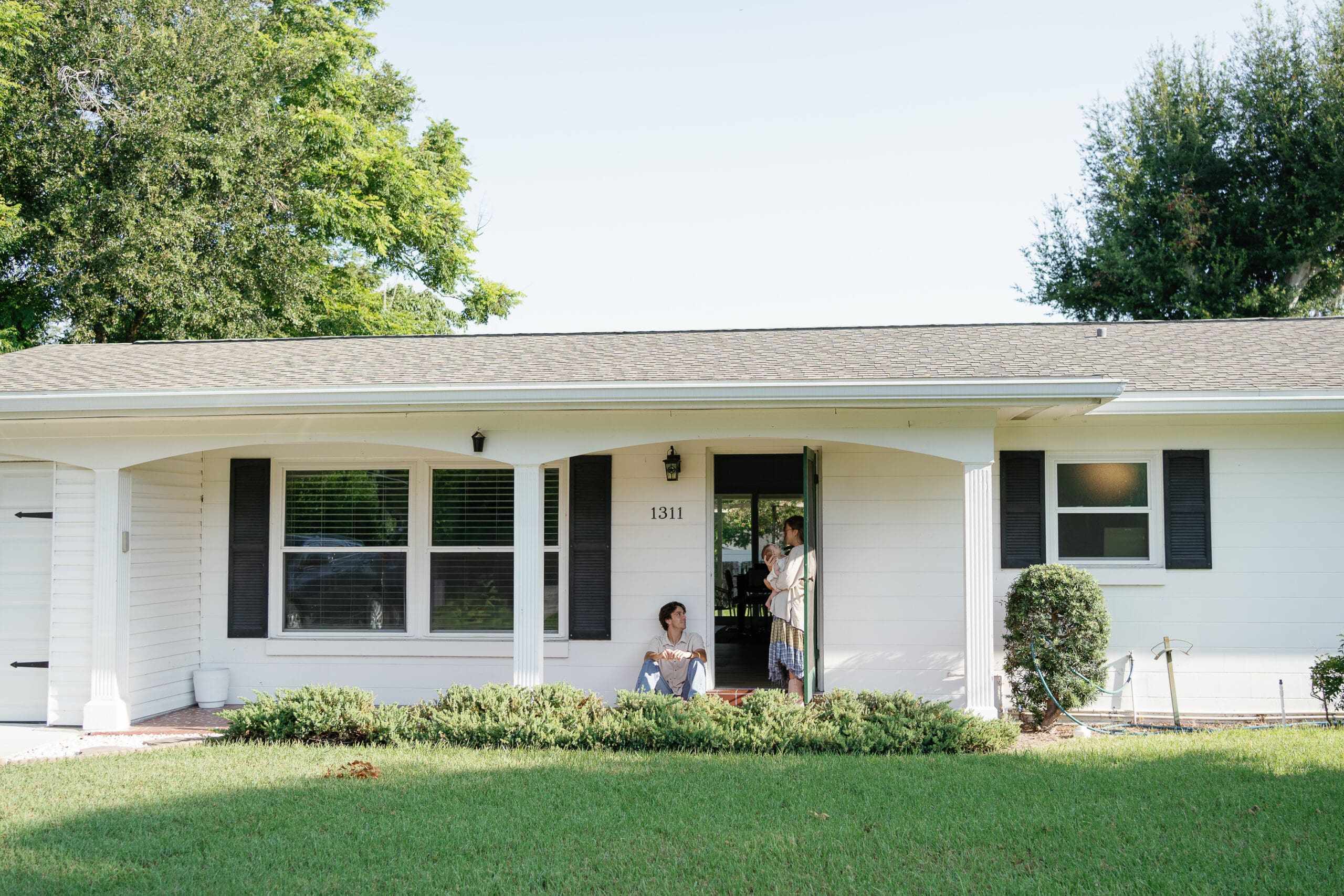 Couple standing in front of their home in Winter Park