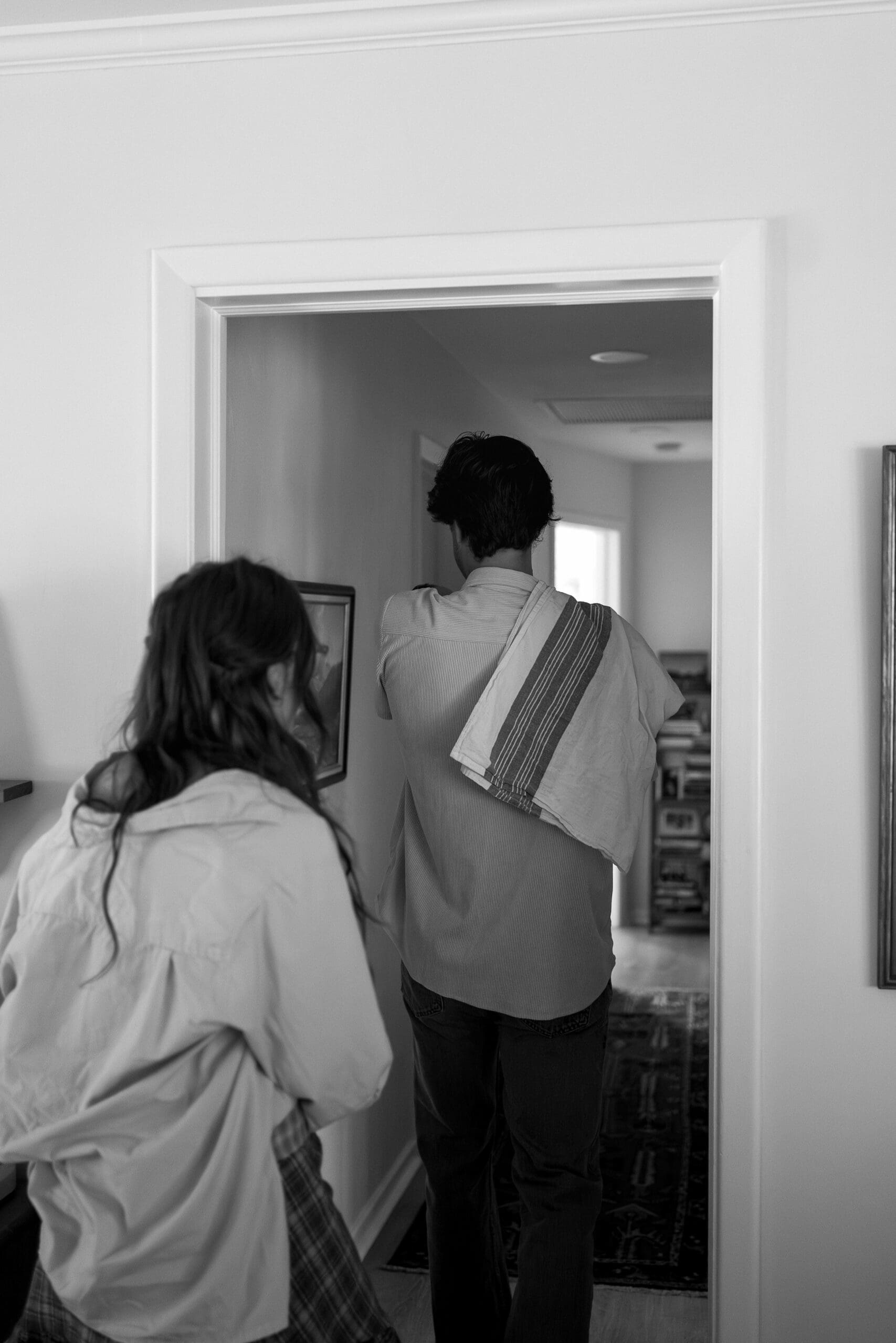 Couple holding baby and walking into the hallway of the nursery by Shelby Ann Photos