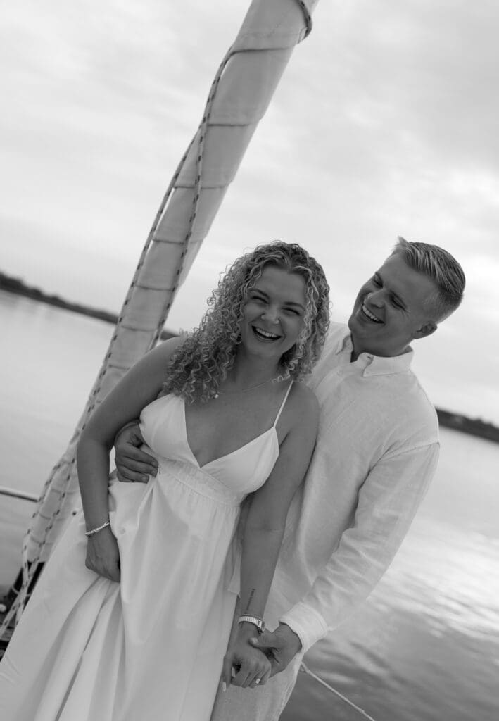 Couple laughing and looking at the camera for engagement session