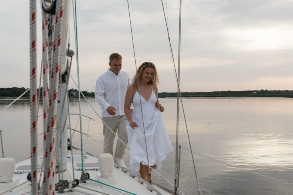 Couple walking together on a sailboat for engagement session
