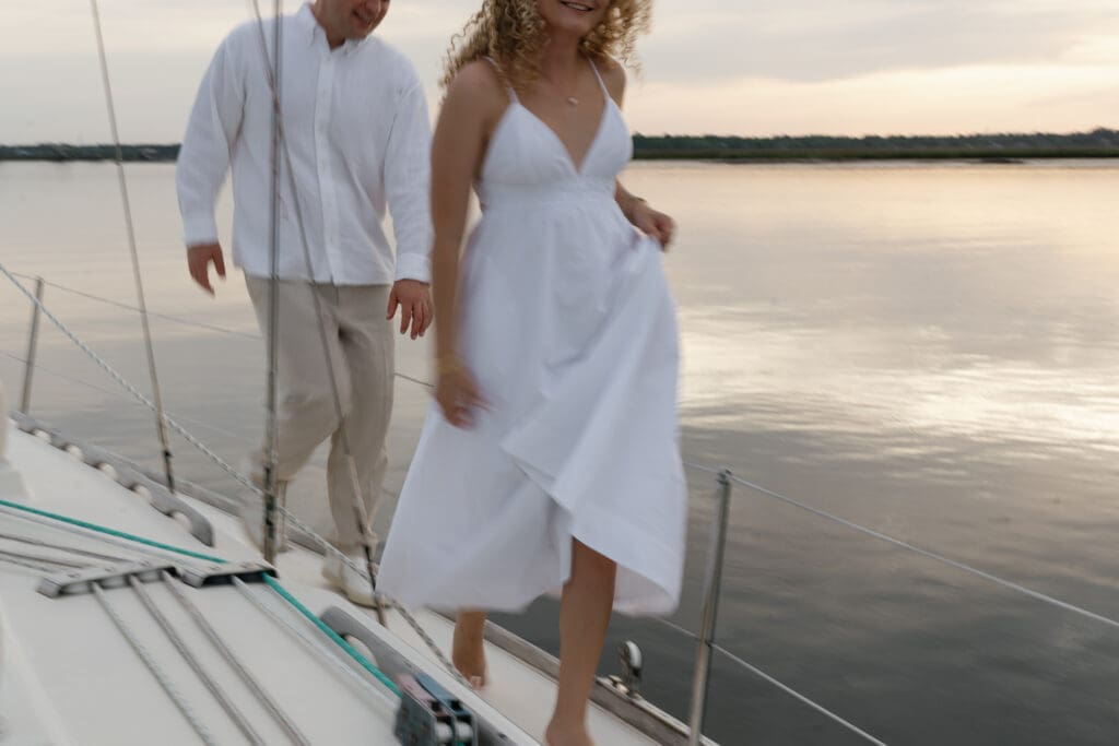 Motion blur of couple running around on a sailboat