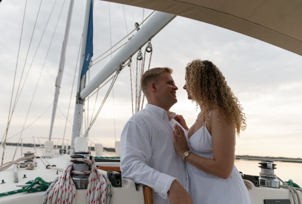 Couple leaning into each other on a boat taken by Shelby Ann Photos